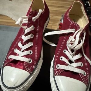 Converse burgundy Canvas Sneakers never been used but has a stained